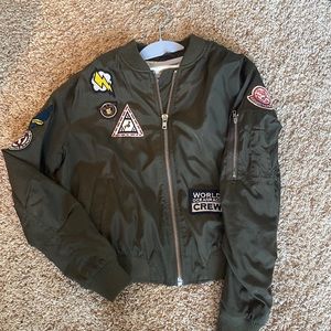 army green bomber jacket by Callie Mac. pockets. patches